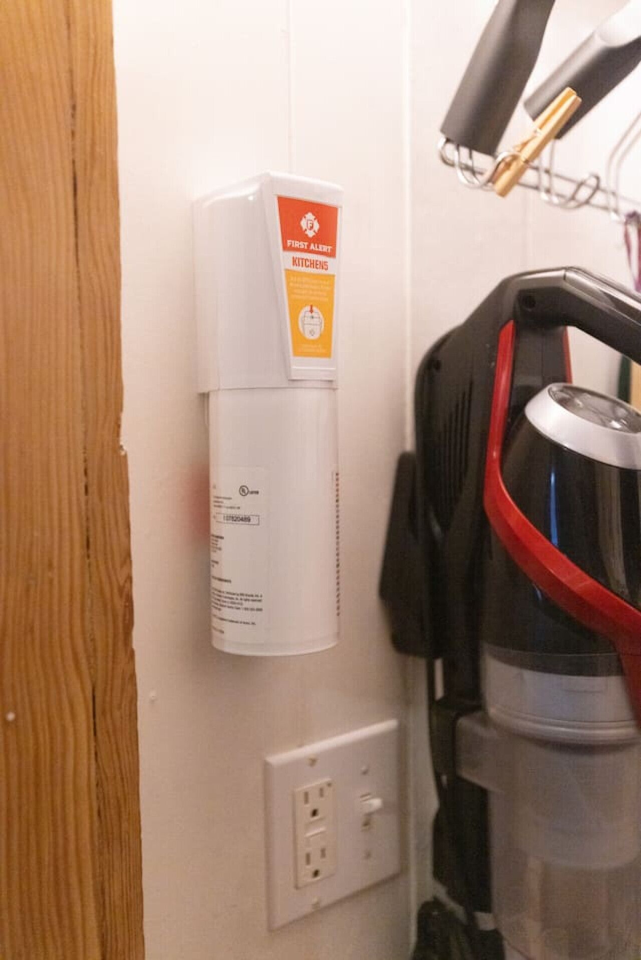 A wall-mounted first aid kit and a water dispenser in a room.