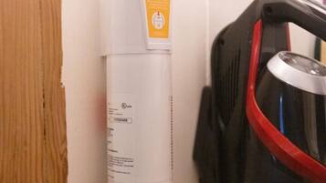 A wall-mounted first aid kit and a water dispenser in a room.