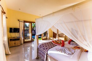 A spacious bedroom with a large bed, a TV, and a balcony with glass doors. - Asri Sari Villa Ubud (Ubud)