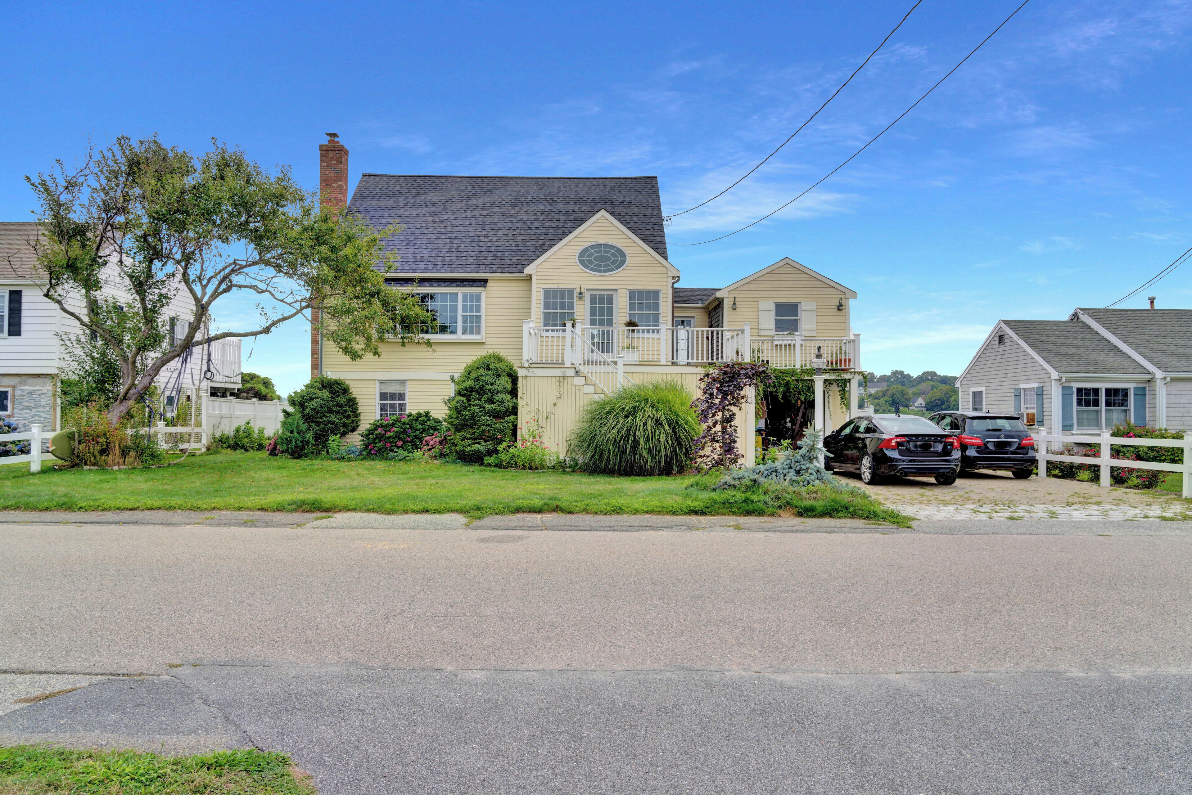 A two-story house with a front porch, a garage, and a driveway.