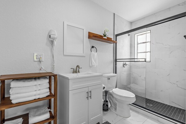 Shower, hair dryer, towels, soap