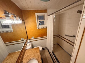 Shower, hair dryer, towels, toilet paper