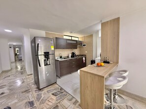 Fridge, microwave, stovetop, coffee/tea maker