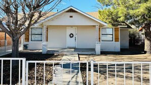A single-story house with a front porch, a garage, and a small attached garage. - Clean, Cute, and Comfortable (Safford)