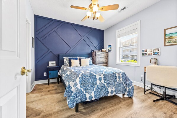 A bedroom with a bed, a dresser, a desk, and a window with a view. - Come stay at our MYRTLE BEACH ESCAPE! Minutes from everything! (Myrtle Beach)