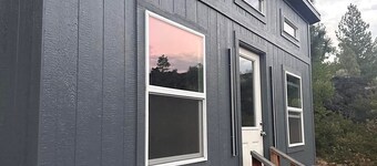 Adorable tiny home cozied up to lava rock!