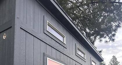 Adorable tiny home cozied up to lava rock!