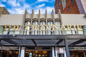 Das äußere Erscheinungsbild des The Ordinary Gebäudes mit Schildern für Unterhaltung, Essen und Getränke.
