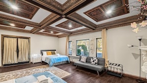 A spacious bedroom with a large bed, a sofa, and a desk. - Stunning Roman Design 7bed5bath in Heart San Jose (San Jose)