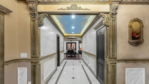 A hallway with ornate moldings, a marble floor, and a ceiling with a skylight. - Spaciour 4Br 4bth Stunning House With Free Parking (San Jose)