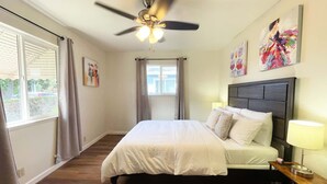 A bedroom with a bed, a ceiling fan, a window with curtains, and artwork on the wall. - Campbell Cozy Bright 2B 1b AC Close to Downtown (Campbell)