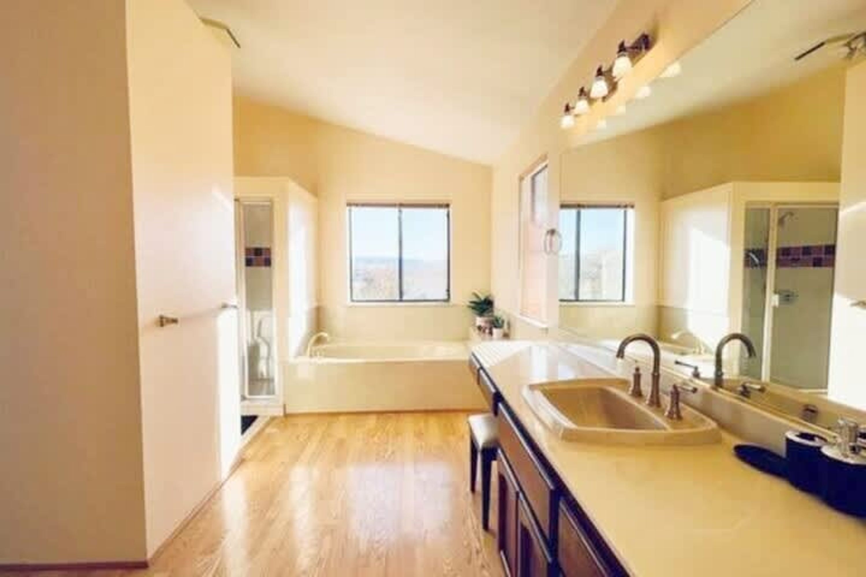 A spacious kitchen with a large window, a built-in oven, and a sink.