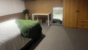 A bedroom with a bed, a desk, a wardrobe, and a mirror. - This property is shared with the Host. On the corner in a welcoming neighborhood (Lima)