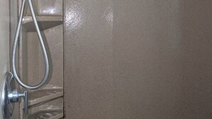 A shower with a handheld showerhead and a flexible hose. - This property is shared with the Host. On the corner in a welcoming neighborhood (Lima)