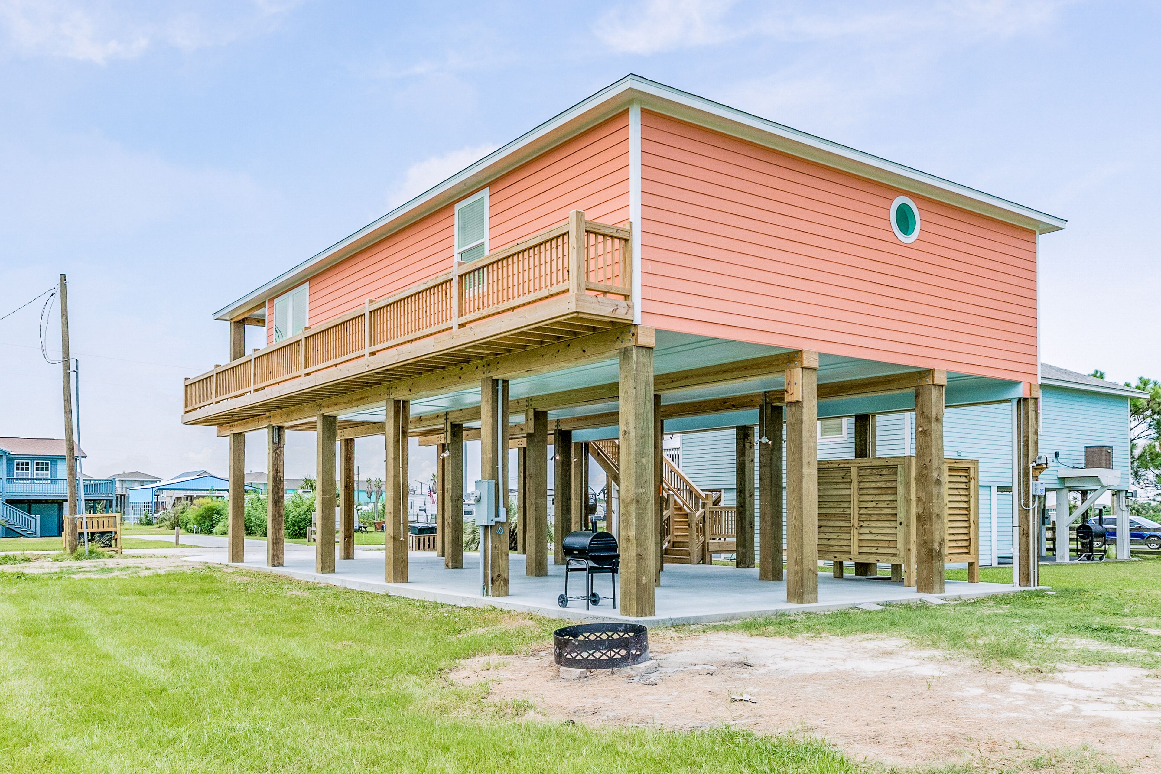 A two-story house with a covered porch supported by wooden posts.