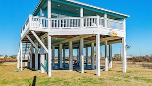 A two-story building with a balcony and a covered area.
