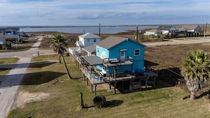 A coastal house with a deck and a view of the sea. - Retreat | Gulf Views | Large Deck | Family Fun (Surfside Beach)