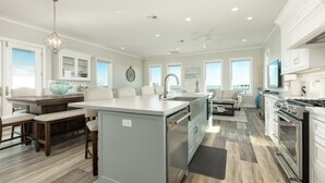 A spacious kitchen with a central island, built-in appliances, and ample counter space. - Luxury Ocean View l Pool l Free Cancellation (Crystal Beach)