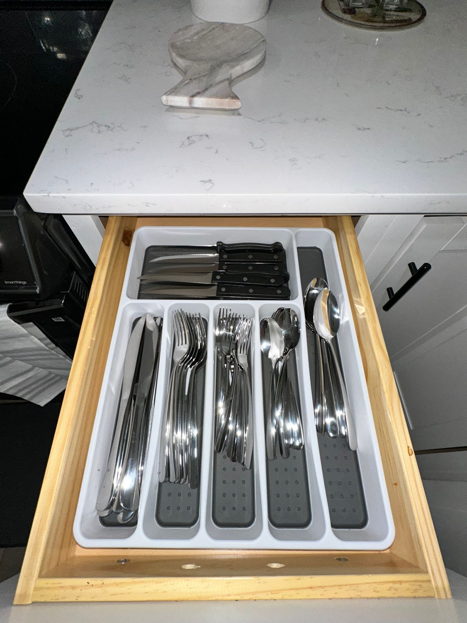 A kitchen drawer with utensils neatly organized.