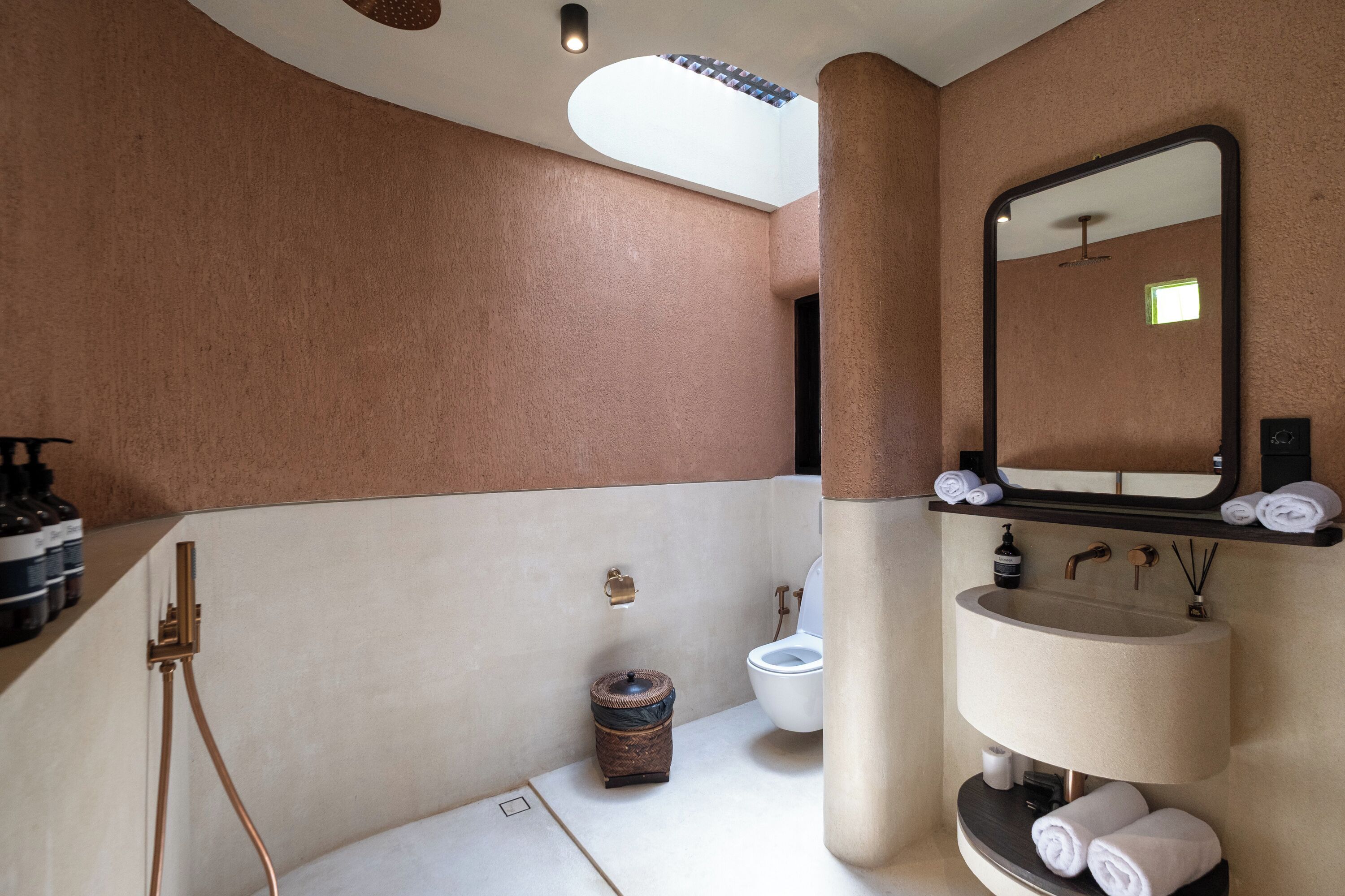 A bathroom with a bathtub, a toilet, a sink, and a mirror.