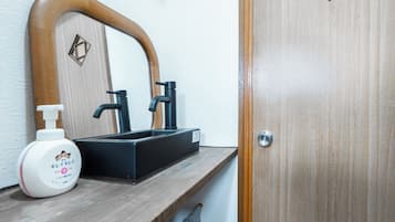 Shower, hair dryer, slippers, towels