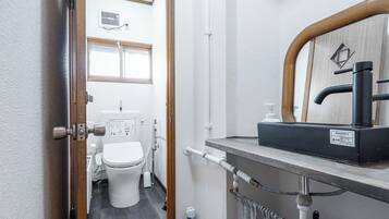 Shower, hair dryer, slippers, towels