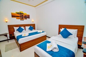 Deluxe Triple Room, Balcony, City View | Desk, laptop workspace, soundproofing, iron/ironing board