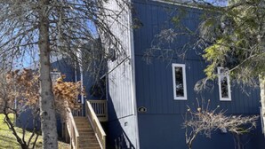 A blue house with a wooden staircase leading to a deck. - Charming 5BR House with Views of the Slopes, Full Kitchen, Patio, and Wifi (Beech Mountain)