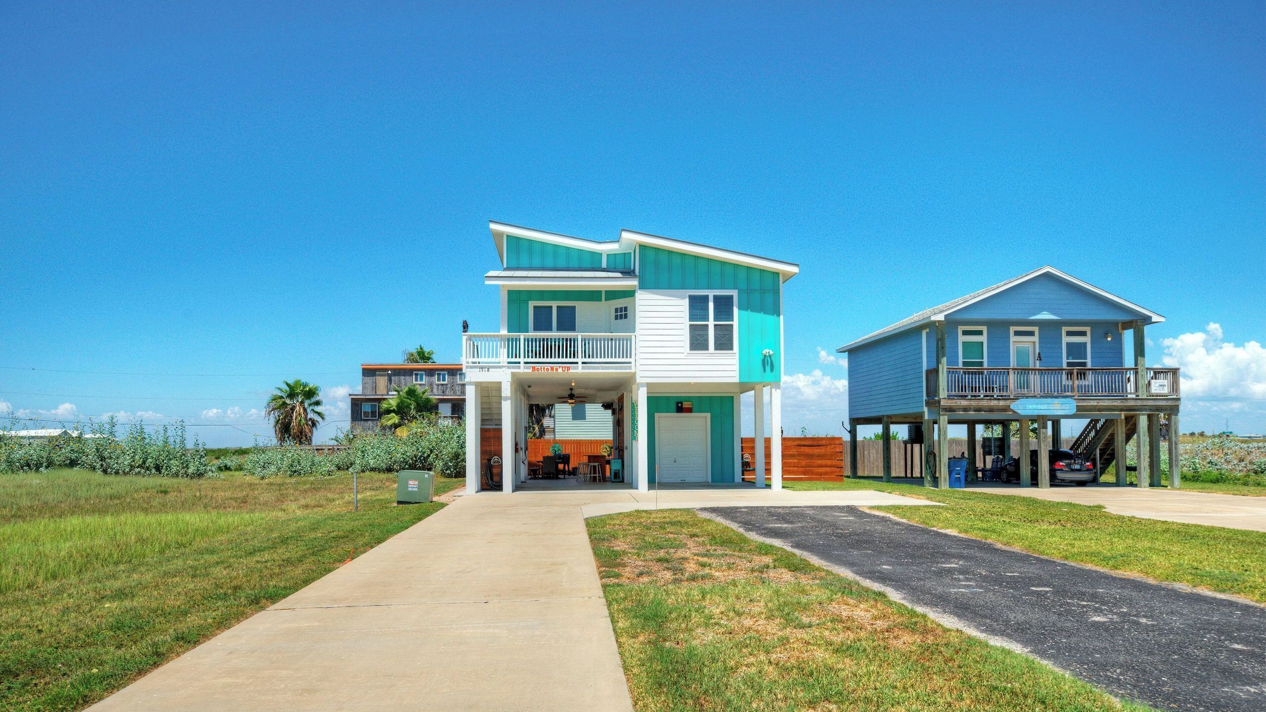 A two-story house with a balcony, a garage, and a covered porch.