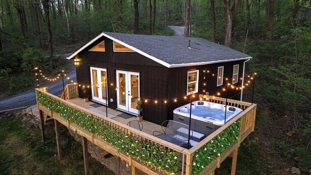 A cabin with a hot tub on a deck, surrounded by a forest. - NEW Zen Cabin in the Clouds . Hot Tub, Wineries, Skyline  (Front Royal)