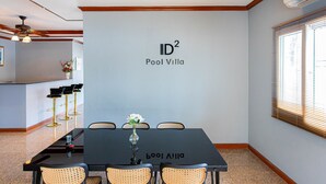 A conference room with a table, chairs, and a logo on the wall.