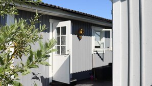 A white building with a wooden deck and a door. - 4 Star Holiday Home in Falkenberg (Falkenberg)
