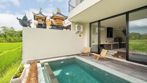A modern house with a swimming pool, a balcony, and a view of traditional Balinese architecture in the background. - Villa Mesra Stunning Paddy Fields Views - Canggu Berawa (Bali)