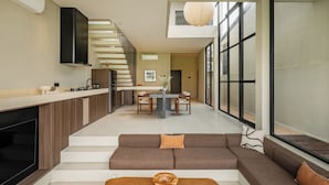 A modern interior with a kitchen, dining area, and seating space. - Villa Mesra Stunning Paddy Fields Views - Canggu Berawa (Bali)