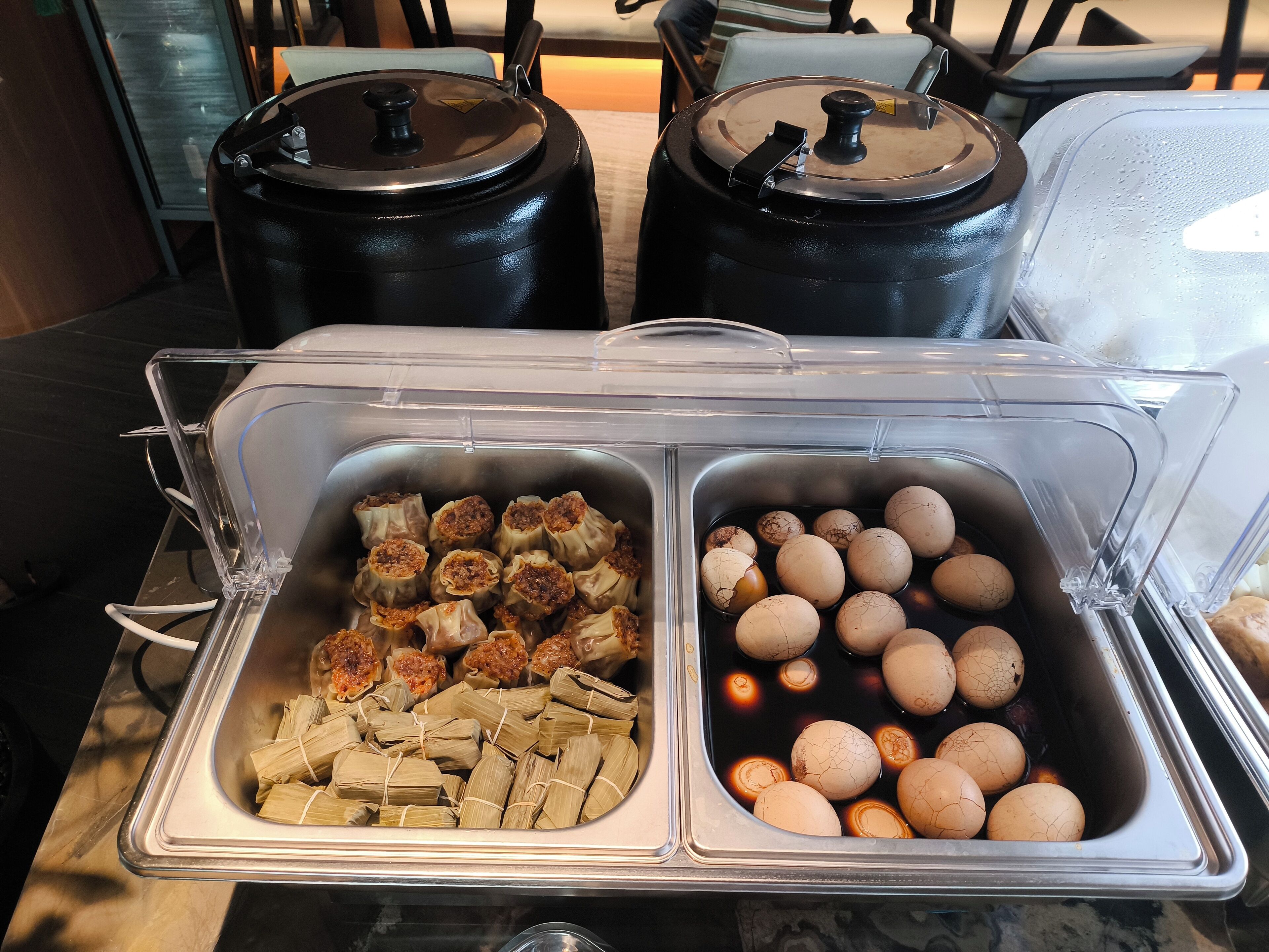 A buffet with two sections: one with tamales and another with boiled eggs.