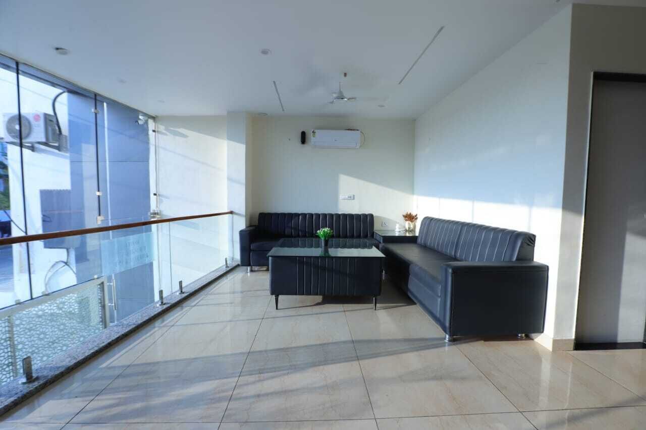 A modern lounge area with a sofa, a coffee table, and a glass railing.