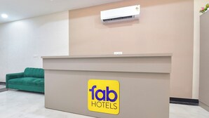 A reception desk with a sign for 'fab hotels'. - Fabhotel Cozzy Stay (Jaipur)
