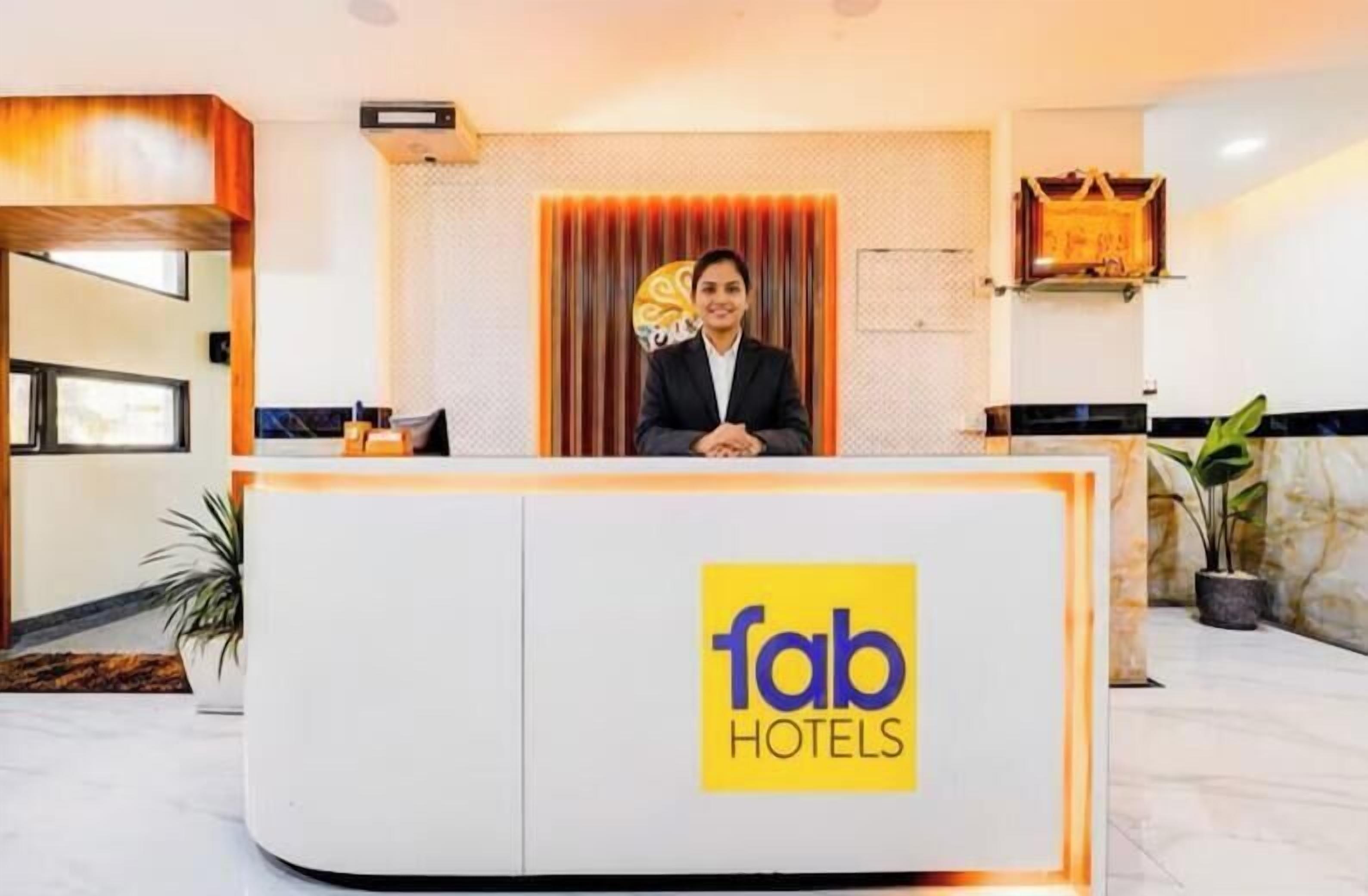 A reception desk with a logo for 'fab hotels'.