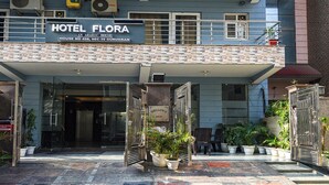 Hotel Flora, an Arabic house with a stone facade and a signboard. - Fabhotel The Flora (Gurugram)