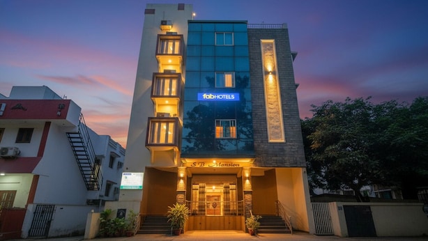 A modern hotel with a prominent 'fabHOTELS' sign, a 'SB Mansion' entrance, and a well-lit facade. - Fabhotel Delight Suite Service Apartments (Bangalore)