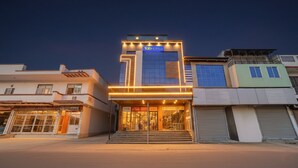 A modern hotel with a prominent entrance, a visible sign for 'Tab Hotels', and a well-lit facade. - Fabhotel Kr Inn (Mathura)