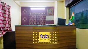 A reception desk with a logo for 'fab hotels'. - Fabhotel Ashiyana (Pune)