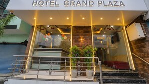 The entrance of Hotel Grand Plaza with a modern facade, glass doors, and a staircase leading to the lobby. - Fabhotel Mahak Palace (Ujjain)