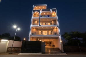 A multi-story hotel with a modern design, featuring balconies on each floor and a sign reading "fabHOTELS". - FabHotel Naveen Stay (Gurugram)