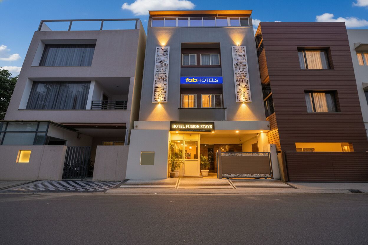 A modern hotel with a flat facade, large windows, and a prominent 'fabHOTELS' sign.