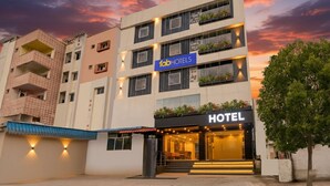 A multi-story hotel with a modern facade, balconies with plants, and a prominent 'fabHOTELS' sign. - Fabhotel Aashvi (Hyderabad)
