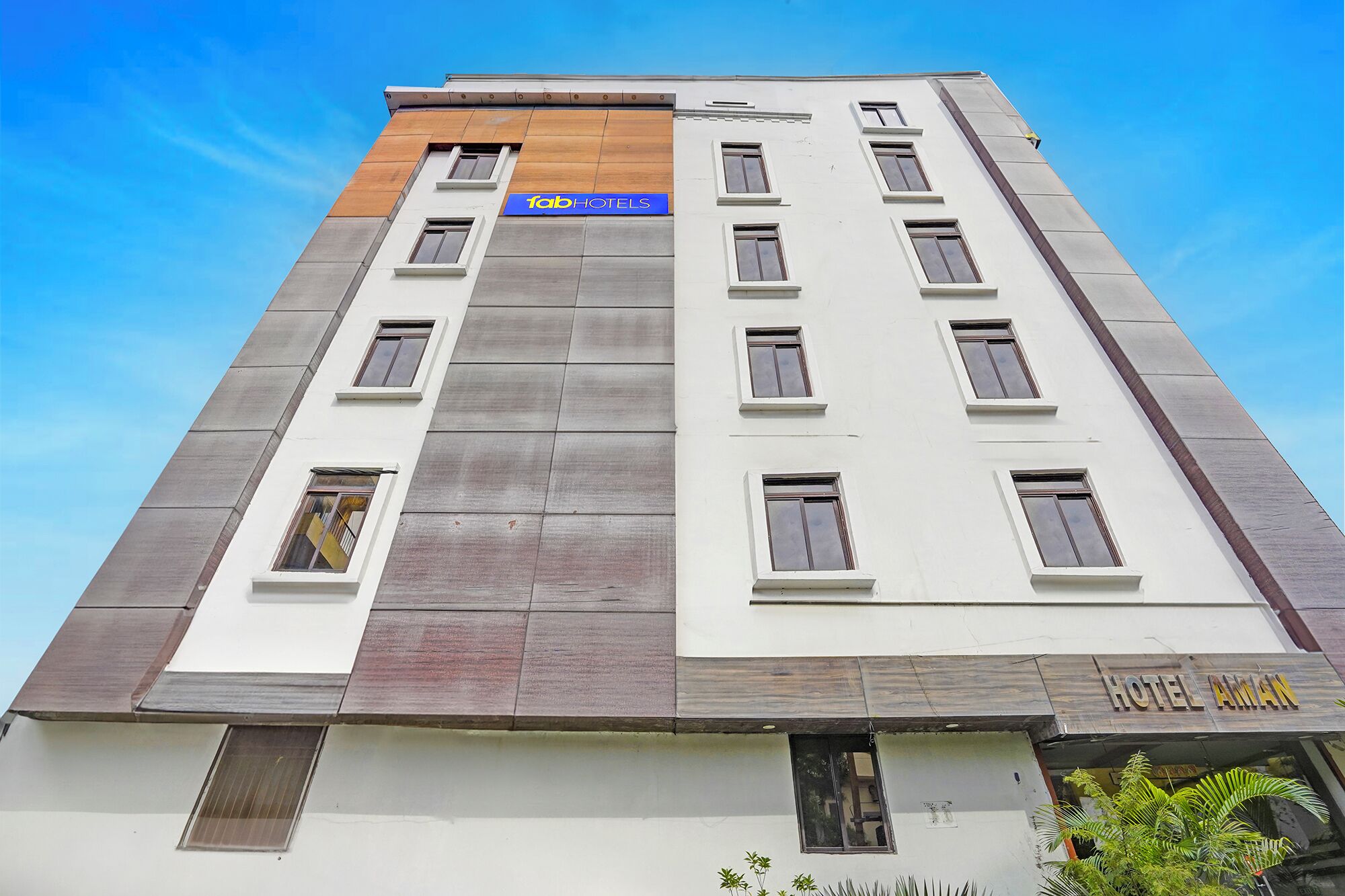 A multi-story hotel with a modern design, featuring a prominent 'Tab Hotels' sign on the facade.