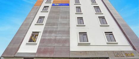 A multi-story hotel with a modern design, featuring a prominent 'Tab Hotels' sign on the facade.