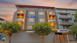 A multi-story hotel with a modern design, featuring balconies and a sign for 'fabHOTELS'. - FabHotel The Tuesday Suits - Opposite to Delhi Public School (Noida)
