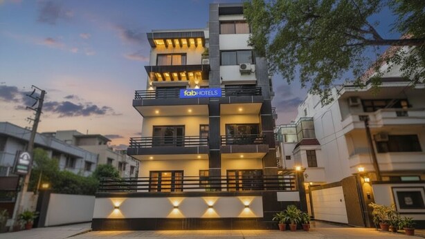 A multi-story building with a modern design, featuring balconies and a sign for 'fab hotels'. - Fabhotel X Green Tree (Gurugram)